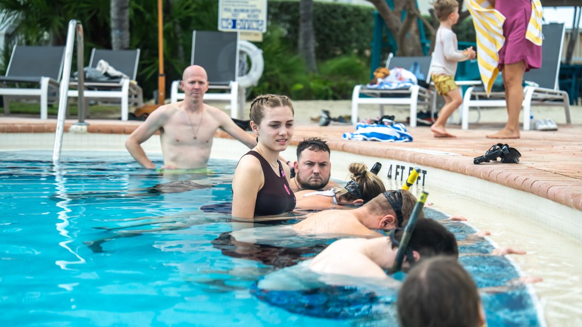 A guest floating face down with a partner spotting
