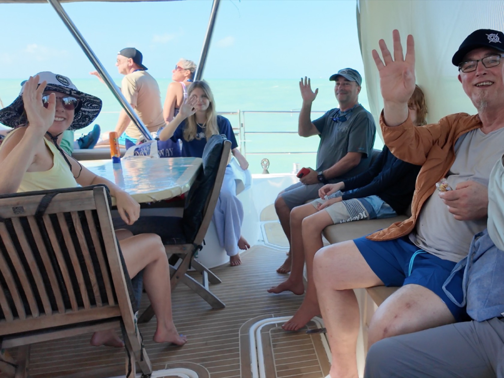 Guests relaxing on the deck of a catamaran under sail