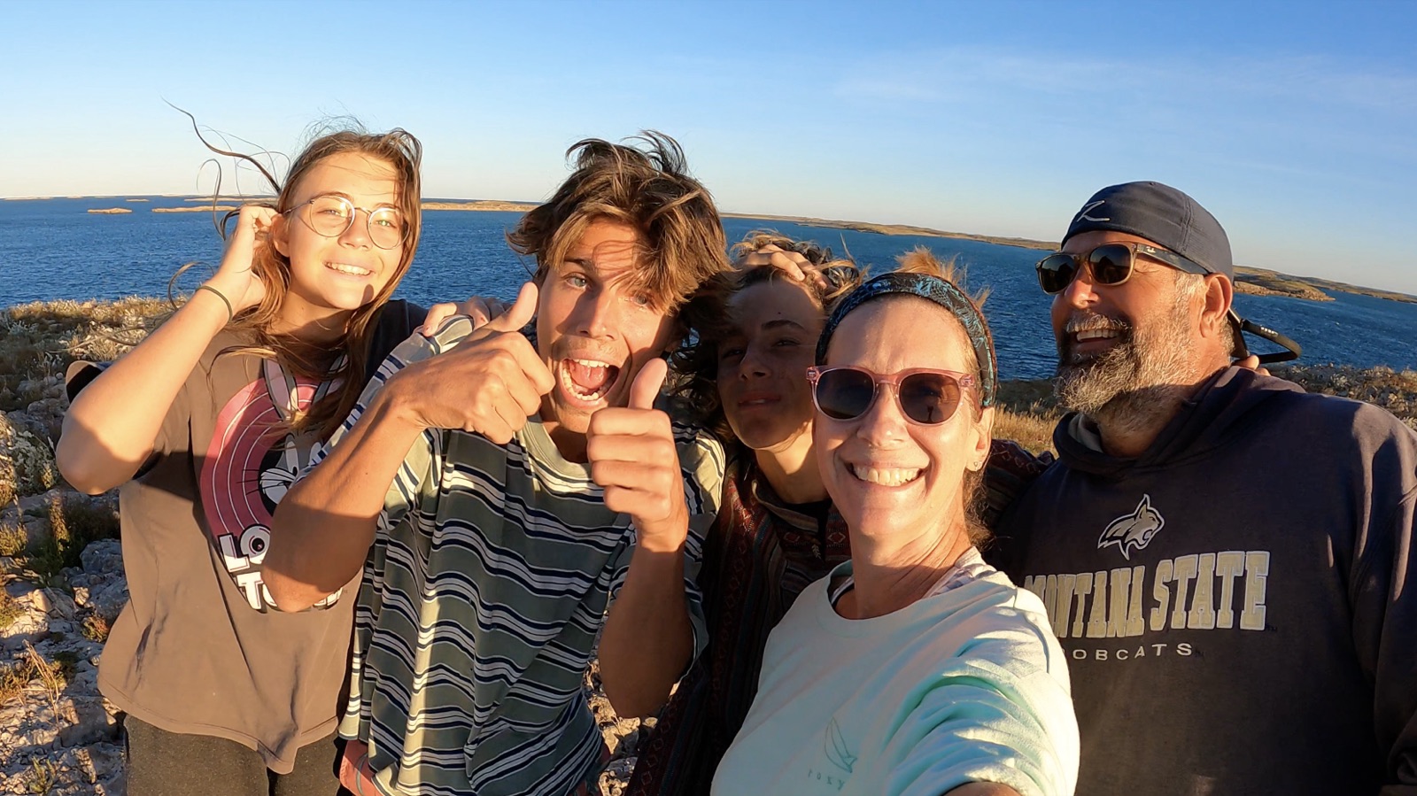 The Zatara family selfie on a rocky shore