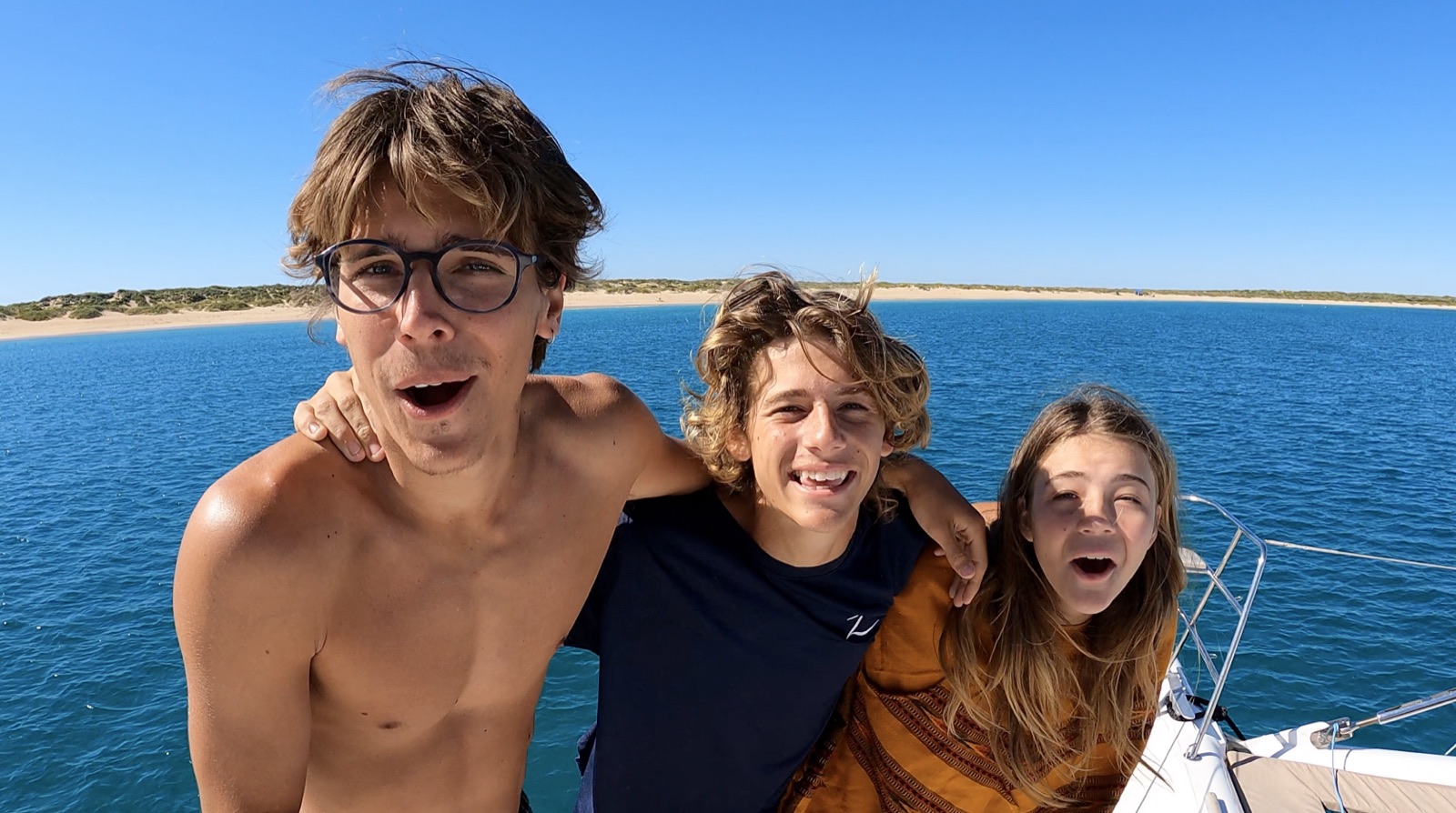 Three of the Zatara kids laughing on the bow